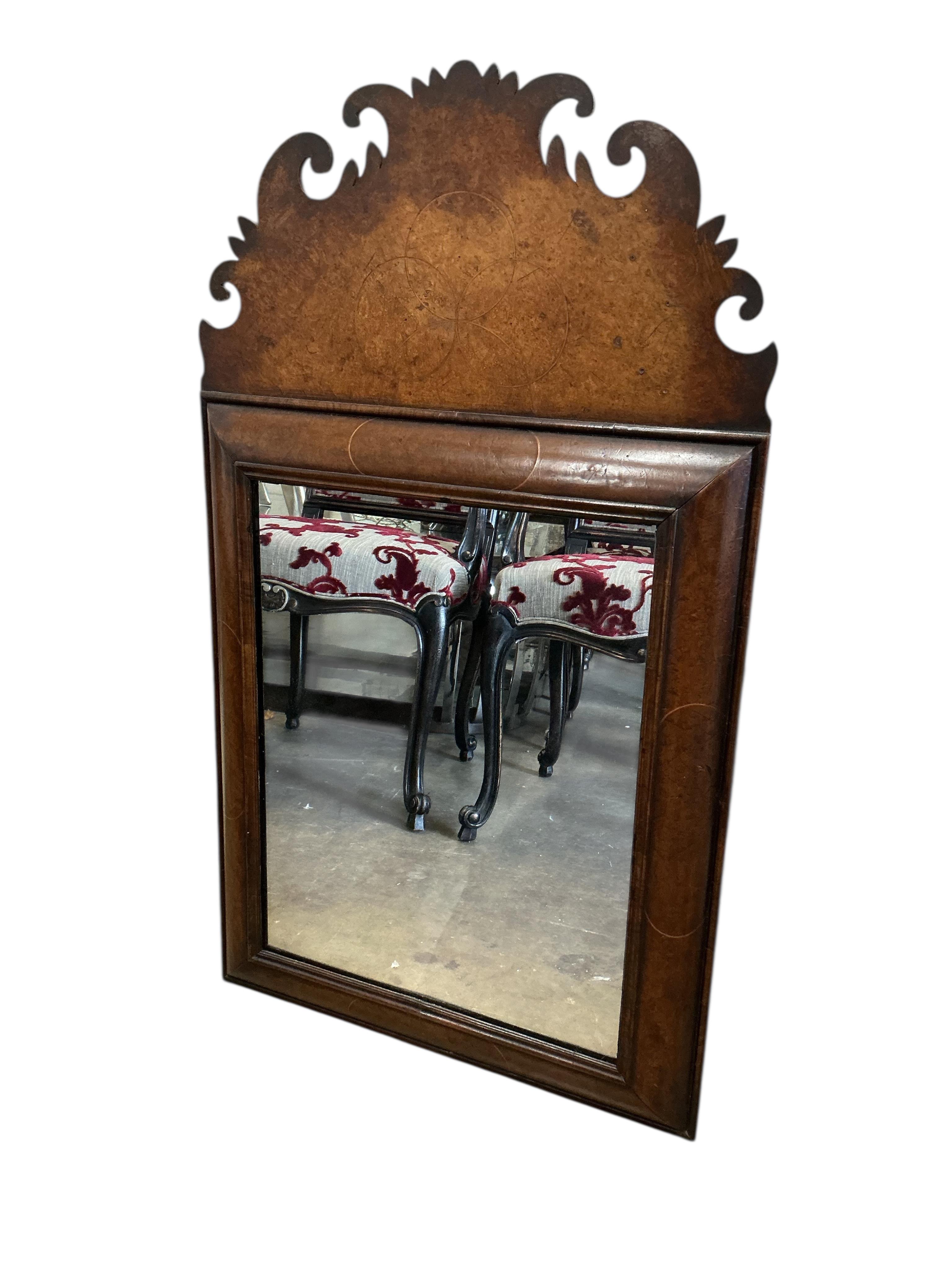 A William and Mary style walnut cushion framed fret cut wall mirror, width 56cm, height 96cm